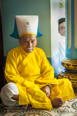 Cao Đài bishop (denoted by the "Divine Eye" embroidered onto his headpiece) waiting for the midday service at the Holy See in Tây Ninh. Photo: Julian Tennant