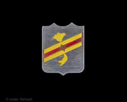 Caodaist Armed Forces (F.A.C.D.) badge worn by the Cao Đài troops of General Trình Minh Thế who had been incorporated into the Vietnamese National Army (F.A.V.N). The locally made badge features a six-pointed star superimposed onto diagonal yellow and red bands representing the Vietnamese national colours and a yellow map of Vietnam, on silver shield. The six-pointed star represents the unification of the six Cao Đài sects.
