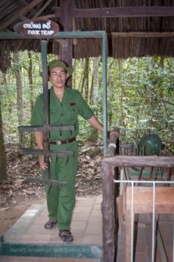 Located about 50km from Ho Chi Minh City, the tunnels at Ben Dinh are one of two such attractions (the other a little further down Provincial Road 15, at Ben Duoc) in the Cu Chi district. Entrance fee is 65000 Dong which includes a guided tour starting in a partially dug in classroom where the guide provides an overview of the tunnel system and its role in the conflict. From there you are shown various exhibits including booby trap and protection measures, command bunkers, hospitals and a munitions manufacturing workshop that recycled unexploded American ordnance. Some, such as the one demonstrating how the infamous ‘Ho Chi Minh sandals’ were made from old tyres allow the visitor to see how the items were made as well as buy the manufactured product. A 50m section of tunnel has been recreated for (larger ‘western’) visitors who wish to experience the feeling of crawling in the dark, dank confines a few meters below the surface. Scattered throughout the site are a handful of war artifacts including a knocked out M-41 tank, munitions and signposts indicating bomb craters, which may otherwise remain unnoticed amongst the rejuvenated undergrowth. At one end there is a café area and 25m shooting range where you can let loose with the usual assortment of M16’s, AK 47’s, M-60’s etc or add some more fake Zippo lighters, dog tags, beer can toys and ‘ho chi minh sandals’ to your collection. For more information go to www.cuchitunnel.org.vn
