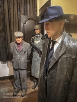 Interrogation display. The caption reads. "September 2, 1944 - At the Kommandantur of Bastogne, the Germans are nervous. The Allied forces are advancing rapidly and members of the resistance are committing more and more acts of sabotage. Close to the railroad, a person has been arrested by a German patrol. Roughly treated by the German soldiers who captured him, the alleged member of the Resistance is presented to a superior officer before being interrogated by the Gestapo. 101st Airborne Museum Bastogne