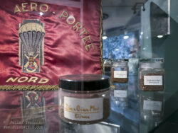 Soil gathered from the various strongpoints around Dien Bien Phu. In the background is the standard ('fanion) of the Base aéroportée nord (BAPN), the principle airborne base and training facility for the airborne forces in the Tonkin region.