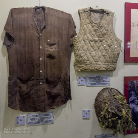 Silk shirt, waistcoat and plant fibre helmet used by Viet Minh forces. Photo: Julian Tennant Dien Bien Phu Victory Museum